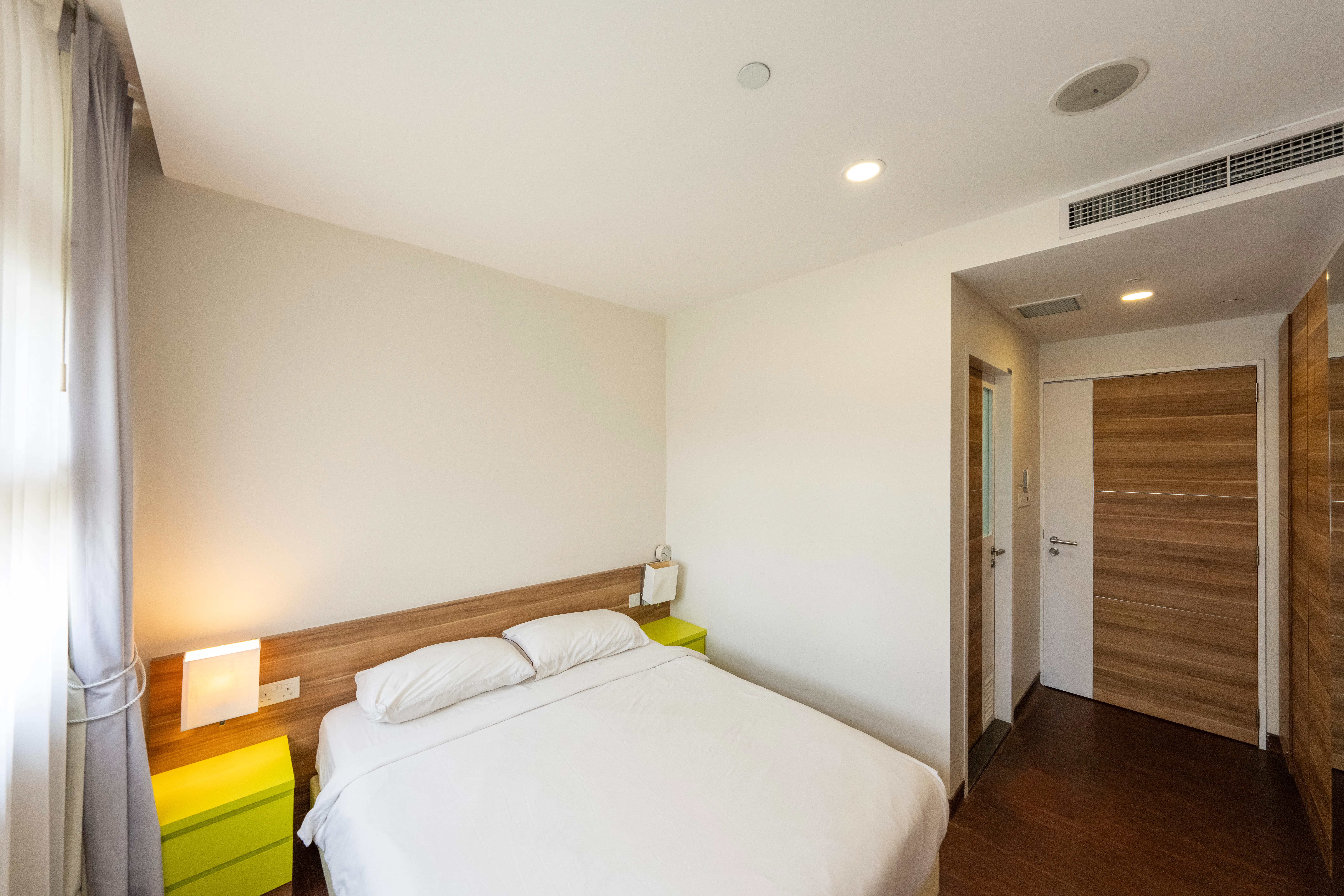 A bedroom in the Ronald McDonald House with a queen bed.